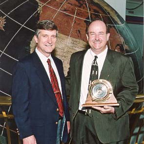 Dr. David Johnson (r), Dean of the College of Arts and Sciences, receives the Coastal Weather Research Center's 2003 Service Award from Dr. Bill Williams (l).