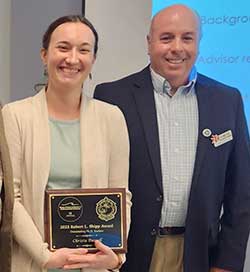 Christa Russell holds her plaque while standing next to mentor Dr. Lee Smee