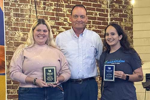
Christopher Davies, Ph.D., center, presents the Edwin R. Hughes Memorial Award to Angela Russ, left, and Sicily Hardy.

