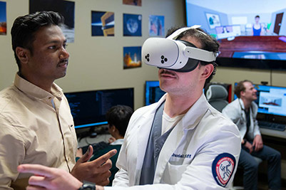 Woman talking in front of screen.