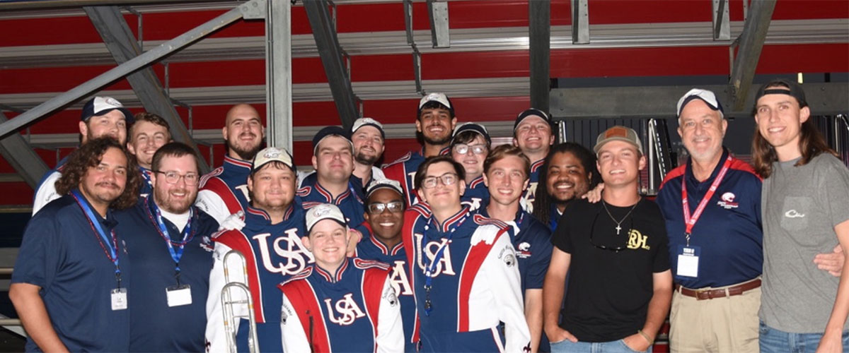 Band performing at game cheering.