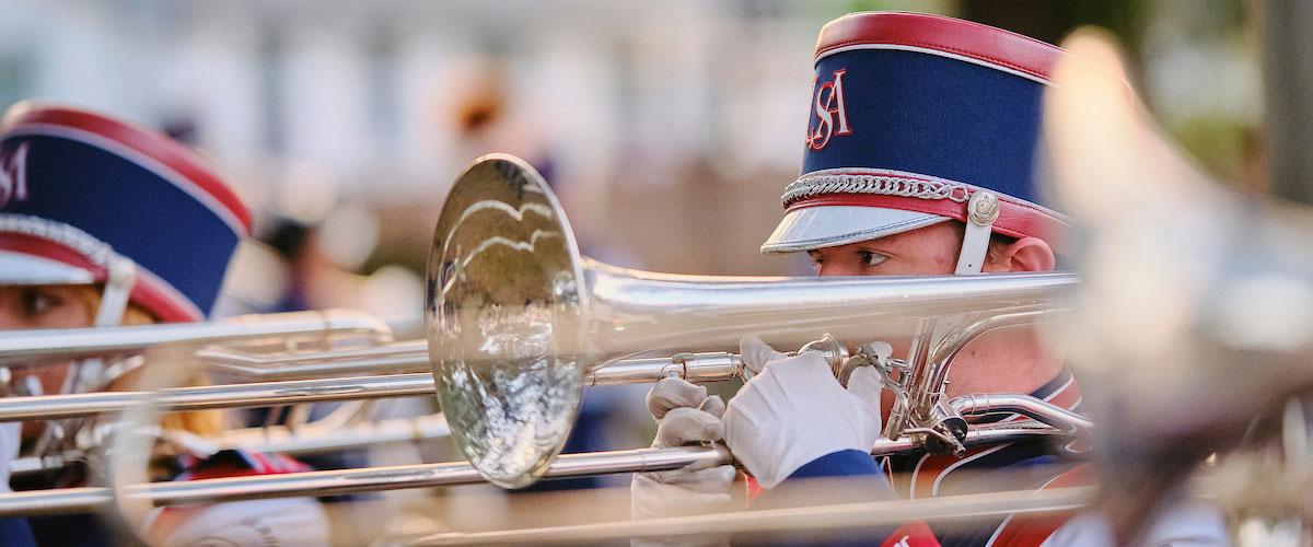 Band performing at game cheering.