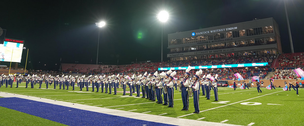 Band performing at game cheering.
