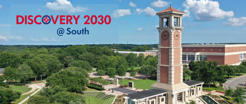 A highway curves across a delta towards a city skyline in the distance.