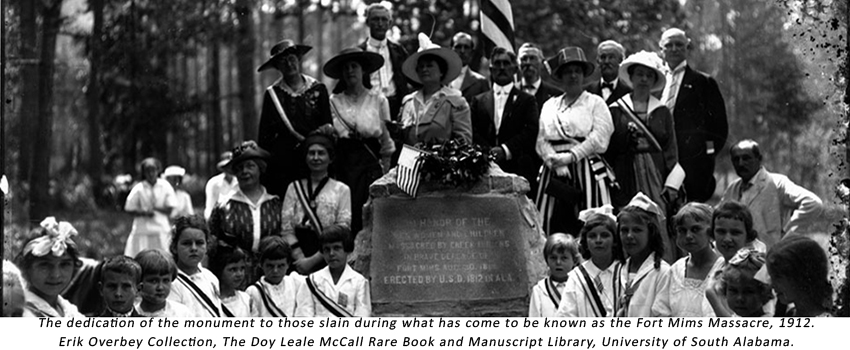 Fort Mims Massacre Dedication Monument. A group of white people stand behind a stone monument in 1912. Source: Eric Overbey Collection, USA Library